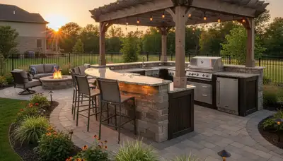 Luxury outdoor kitchen with stone counters and pergola by St. Louis MO landscapers serving Madison IL homes